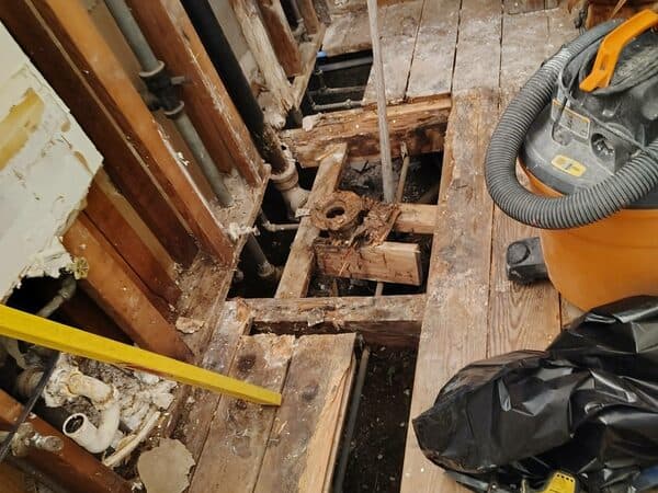 Bathroom Remodeling by DCB Construction Sacramento Stripped floor and wall in an in progress renovation for a bathroom with visible piping for sink and toilet in Sacramento CA