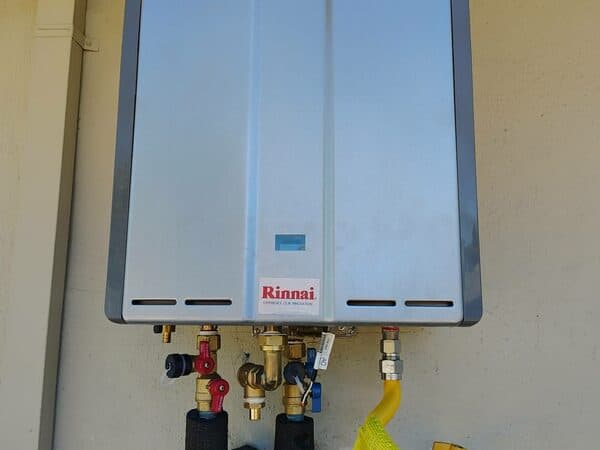 Home Construction by DCB Construction Sacramento A tankless water heater on the outside of a home in Sacramento CA