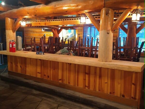Construction Project by DCB Construction Sacramento Interior of a restaurant bar with polished would countertops and lantern style lighting with new wood pillars and countertop and hardwood siding in Sacramento CA