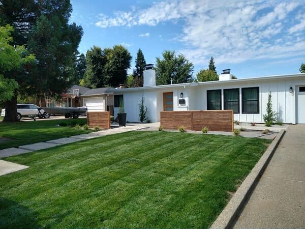 Home Construction by DCB Construction Sacramento Mid century home with a horizonal hardwood fence in Sacramento CA