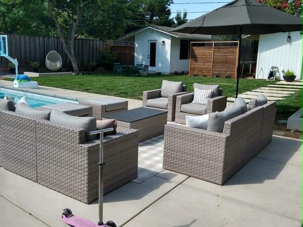 Construction Project by DCB Construction Sacramento Paved patio with furniture and a rug next to a swimming pool in Sacramento CA