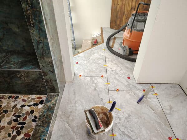Bathroom Remodeling by DCB Construction Sacramento Polished porcelain tile on shower with pebble flooring and tile flooring for bathroom in Sacramento CA