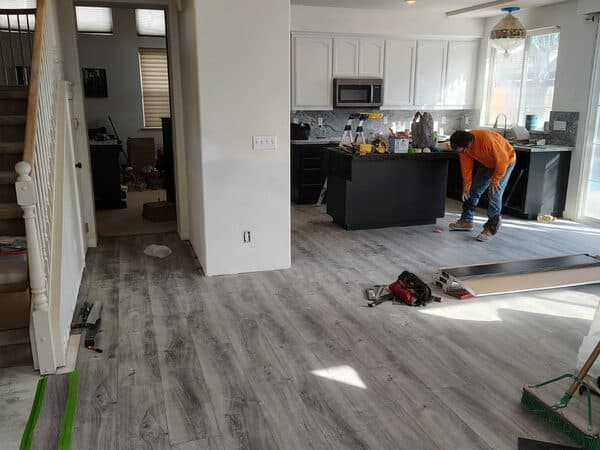 Kitchen Remodeling by DCB Construction Sacramento Working on the interior of a bkitchen dining room installing new floor boards in Sacramento CA