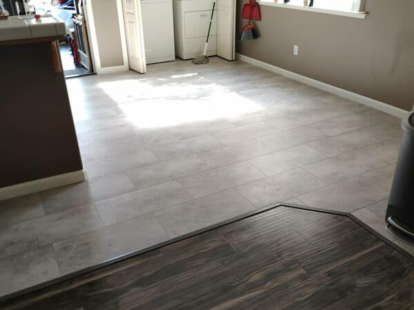 Kitchen Remodeling by DCB Construction Sacramento Tiled kitchen floor meeting the wood tiled living area with a separator. Freshly installed and clean in Sacramento CA
